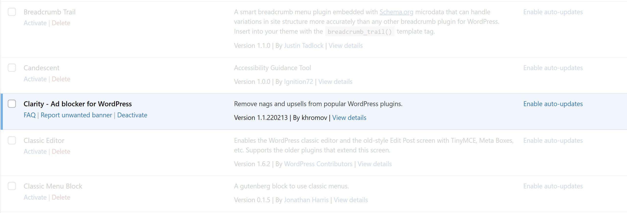 WordPress plugins management screen.  The Clarity plugin is highlighted, and it has an extra link to report and unwanted banner.